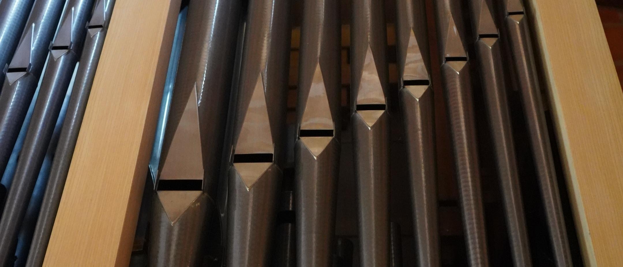acht Orgelpfeifen im Rahmen der Orgel